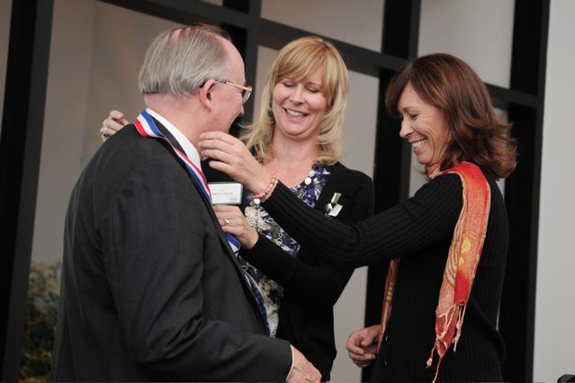 Rohl with Kathryn Martin and Kren Rohlf presenting a "medal"