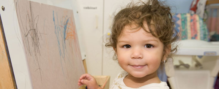 child drawing on canvas