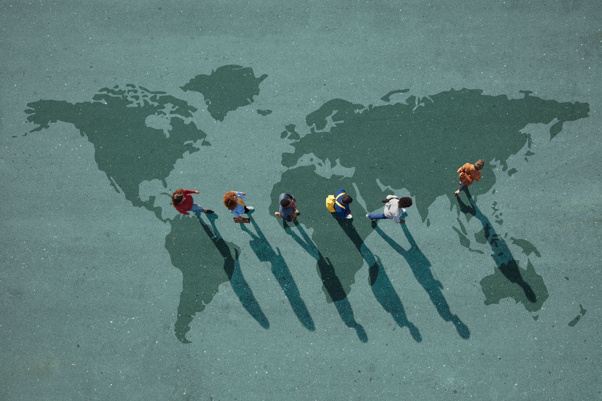 People walking across map of world