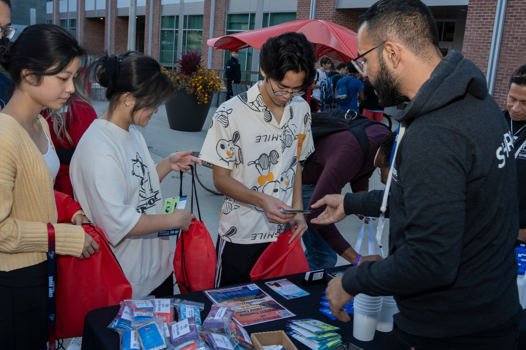 students at an HIV education table